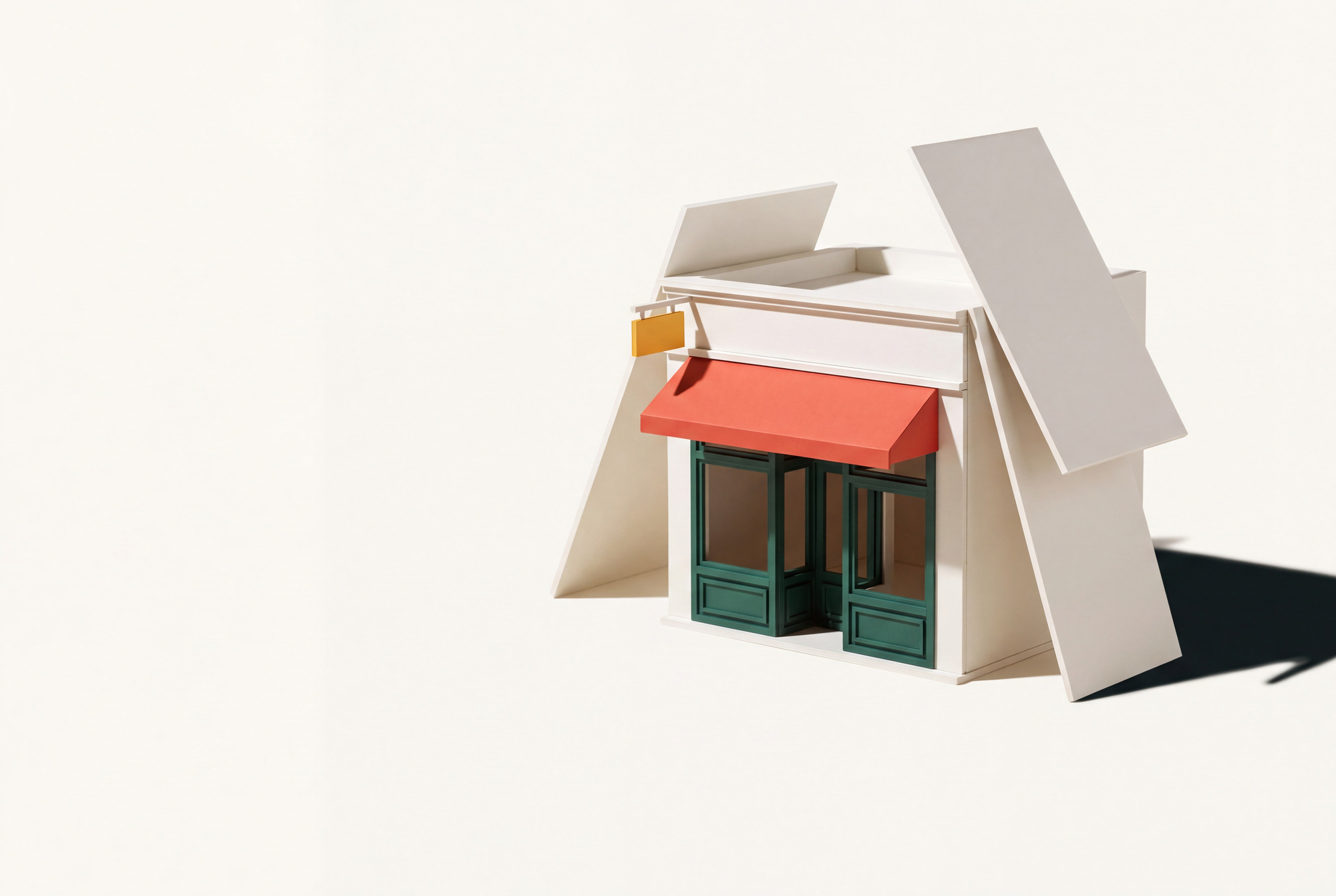 A miniature model of a storefront being assembled on a studio table